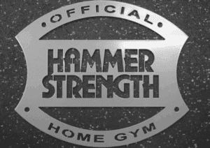 Hammer Strength Logo mit Schriftzug „Official Home Gym“ auf grauem Hintergrund